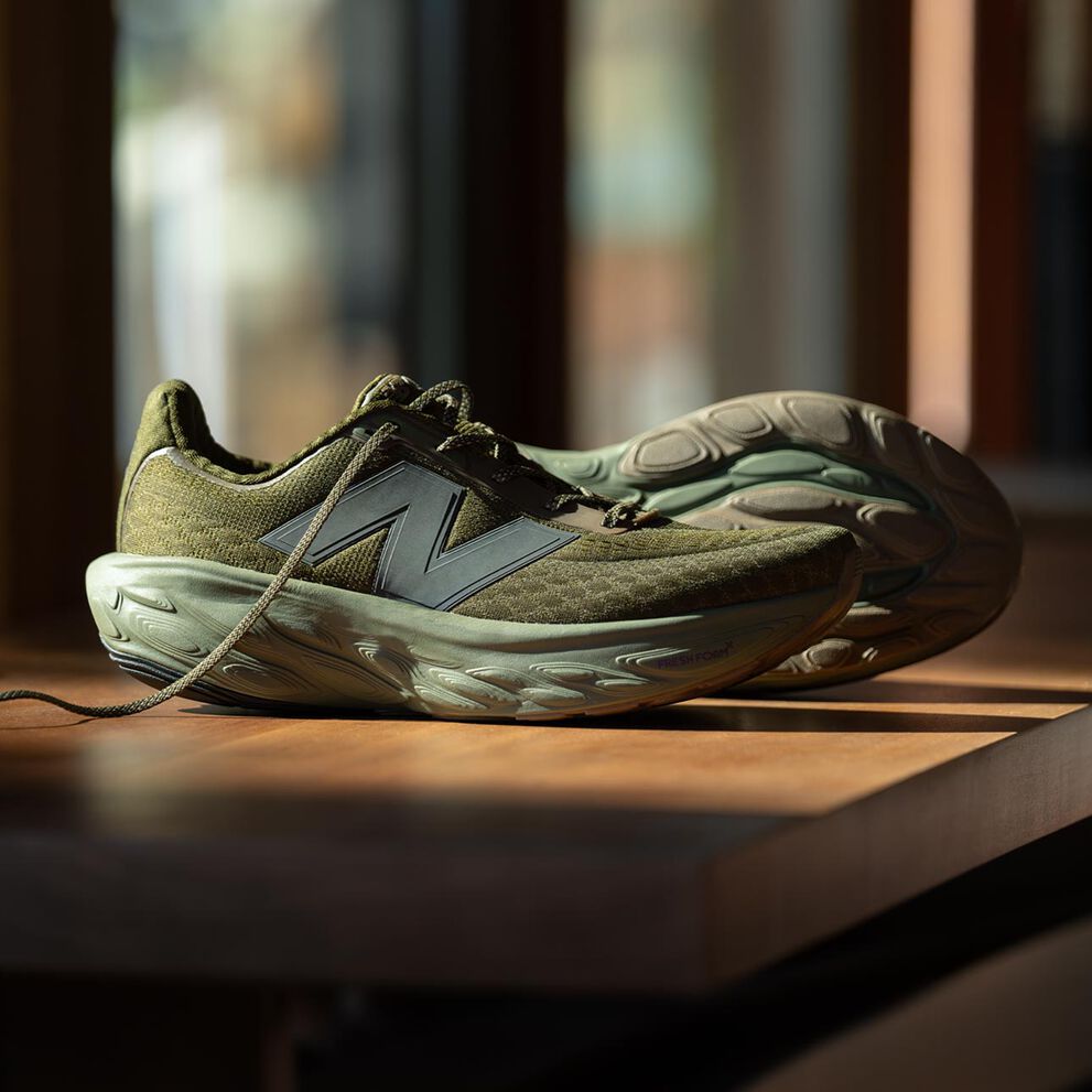 A blue shoe on a dark brown backdrop. 